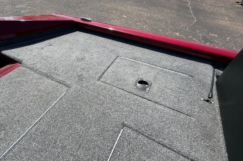 Slide: The Image of 2023 Bass Tracker Pro 17 boat deck with gray carpet and storage hatch. - 30