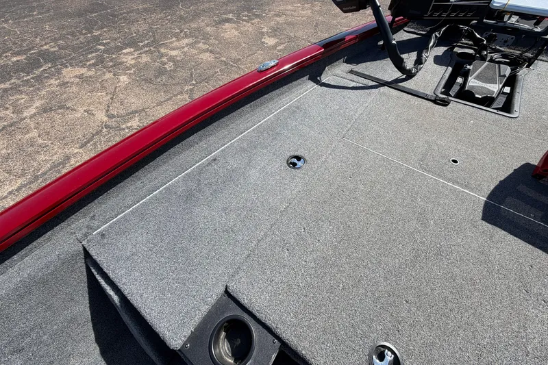 Slide: The Image of 2023 Bass Tracker Pro 17 boat deck with carpeted surface and control panel. - 14