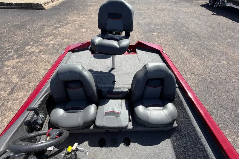 Slide: The Image of 2023 Bass Tracker Pro 17 boat interior with three gray seats and steering wheel. - 22