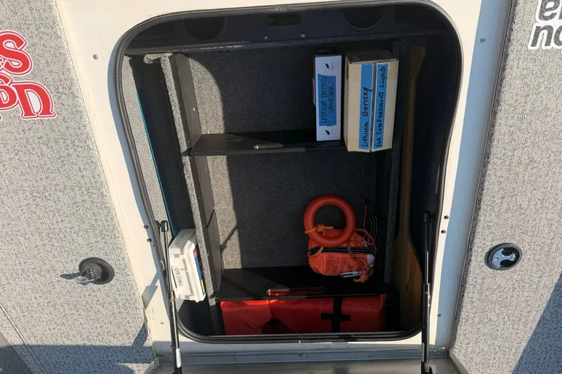 Slide: The Image of Storage compartment of 2023 Tracker Pro Team 190 TX Tournament Edition boat with safety gear. - 53