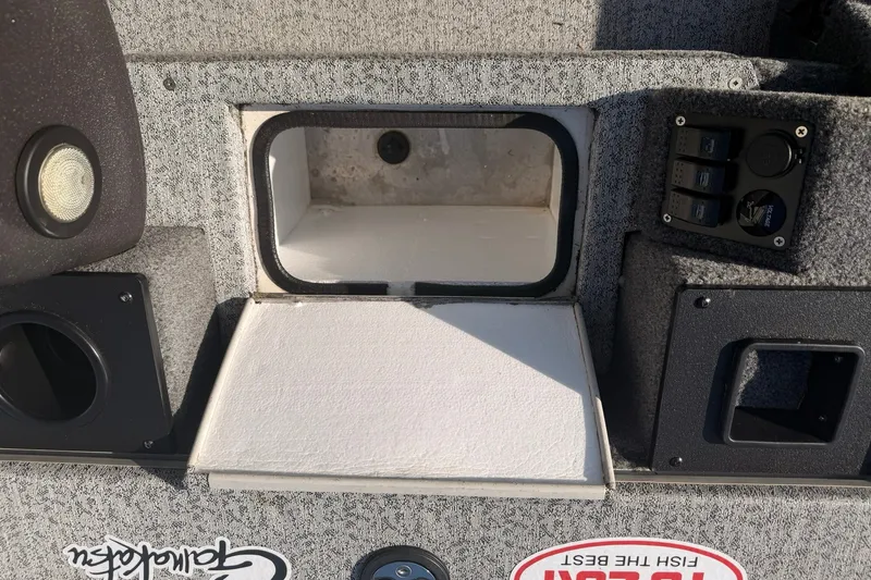 Slide: The Image of 2023 Tracker Pro Team 190 TX Tournament Edition boat interior with storage compartment and control panel. - 52
