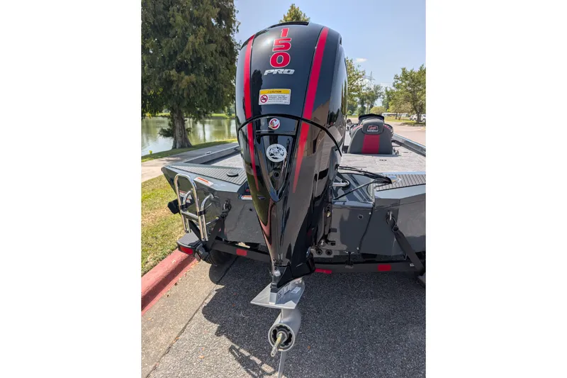Slide: The Image of 2027 Ranger RT198P boat with a powerful 150 Pro outboard motor, parked near a lake. - 11