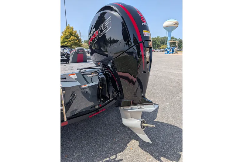 Slide: The Image of 2027 Ranger RT198P boat with a powerful black outboard motor in a parking area. - 10