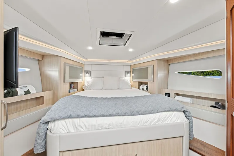 Slide: The Image of Luxurious bedroom interior of 2025 Regal 42 Grande Coupe yacht, featuring modern design and cozy bedding. - 24