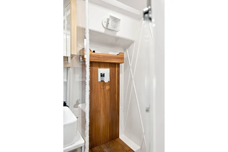 Slide: The Image of Modern bathroom interior of 2025 Regal 42 Grande Coupe yacht, featuring sleek wood accents. - 28