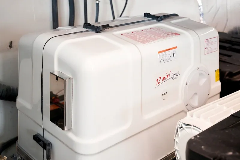 Slide: The Image of Generator unit in a 2025 Regal 42 Grande Coupe yacht engine room. - 40