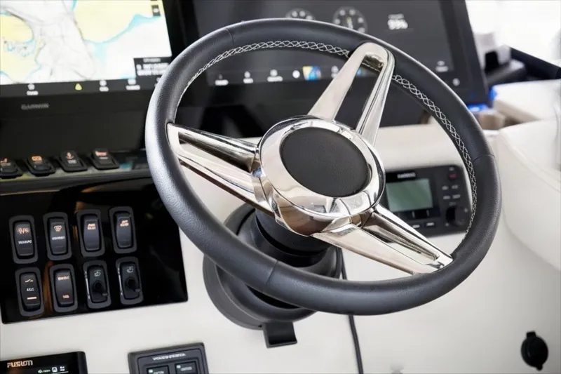 Slide: The Image of Steering wheel of 2025 Regal 42 Grande Coupe yacht with control panel. - 13