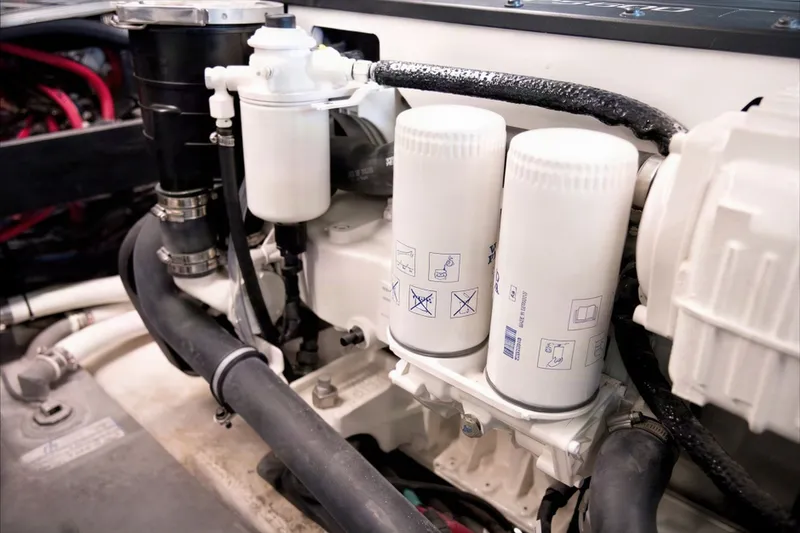 Slide: The Image of Engine compartment of 2025 Regal 42 Grande Coupe, showcasing filters and hoses. - 37