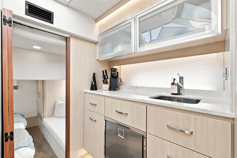 Slide: The Image of Luxurious interior of 2025 Regal 42 Grande Coupe yacht with modern kitchenette and cozy cabin. - 21