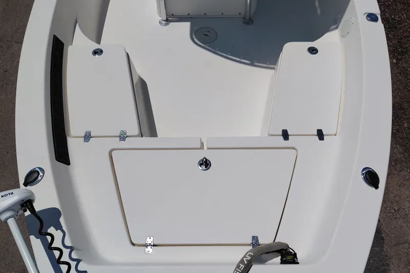 Slide: The Image of 2020 Cobia 21 Bay boat deck with storage compartments and trolling motor. - 14