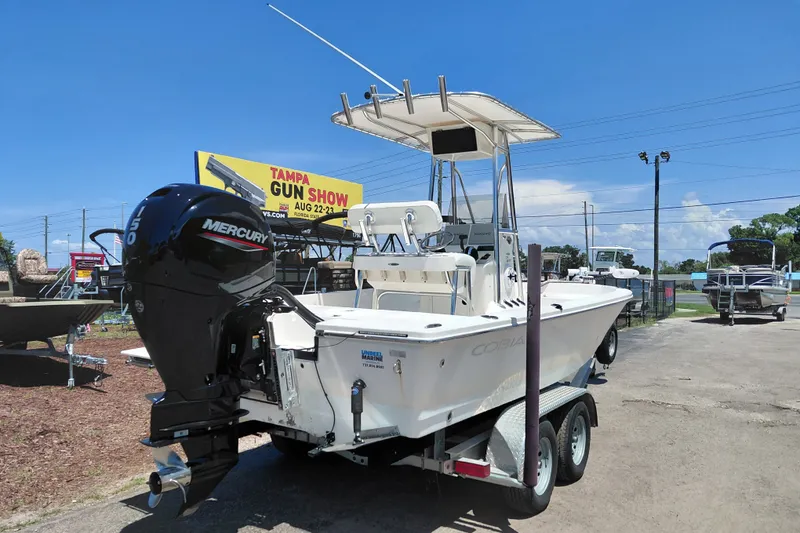Slide: The Image of 2020 Cobia 21 Bay boat with Mercury engine on trailer, outdoor display. - 9