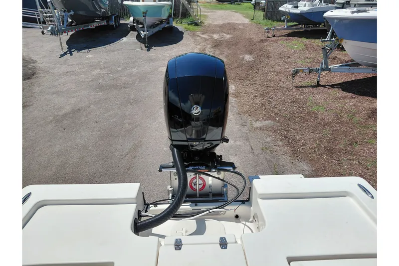 Slide: The Image of 2020 Cobia 21 Bay boat with outboard motor in a marina setting. - 34