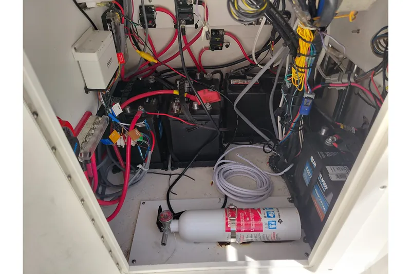 Slide: The Image of 2020 Cobia 21 Bay boat electrical compartment with wiring and batteries. - 41