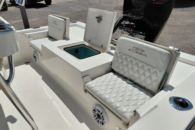 Slide: The Image of 2020 Cobia 21 Bay boat interior with cushioned seating and storage compartments. - 32