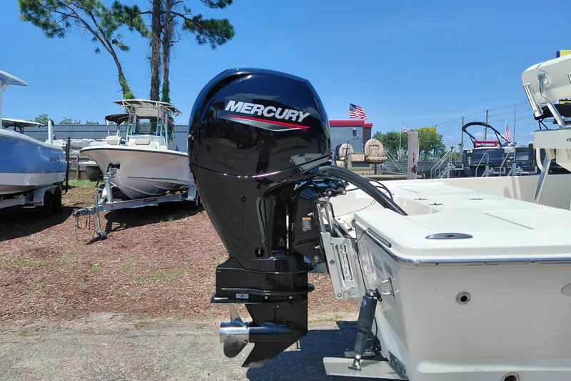 Slide: The Image of 2020 Cobia 21 Bay boat with Mercury outboard motor in a sunny outdoor setting. - 8