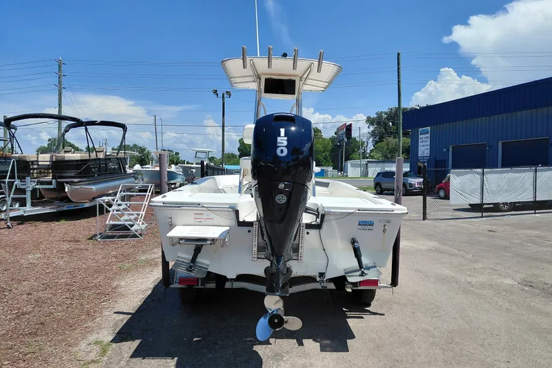 Slide: The Image of 2020 Cobia 21 Bay boat with 150 HP engine in a dealership lot. - 7