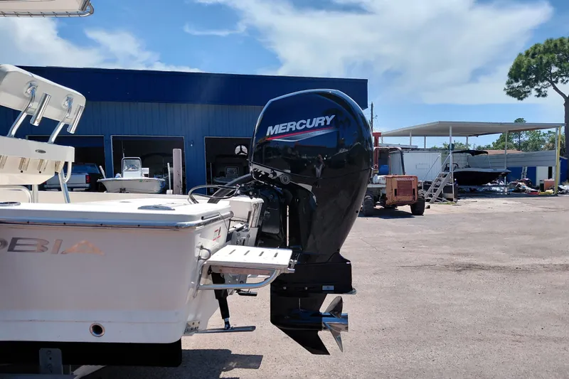 Slide: The Image of 2020 Cobia 21 Bay boat with Mercury outboard motor in a marina setting. - 6
