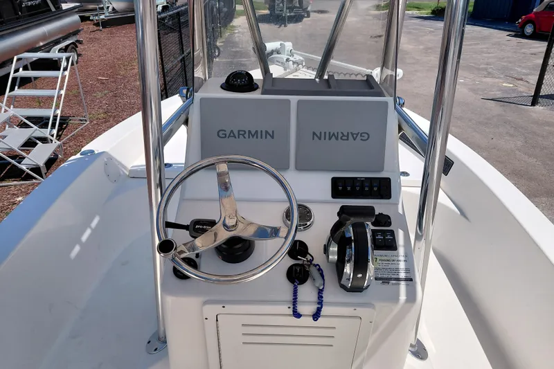Slide: The Image of 2020 Cobia 21 Bay boat console with Garmin navigation system and steering wheel. - 27