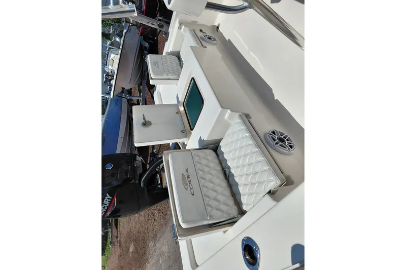 Slide: The Image of 2020 Cobia 21 Bay boat interior with cushioned seating and storage compartments. - 31