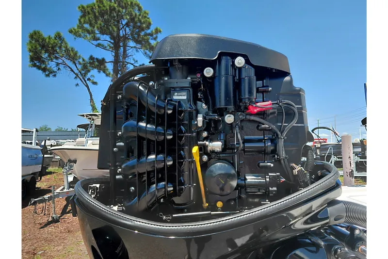 Slide: The Image of 2020 Cobia 21 Bay boat engine close-up under clear blue sky. - 43