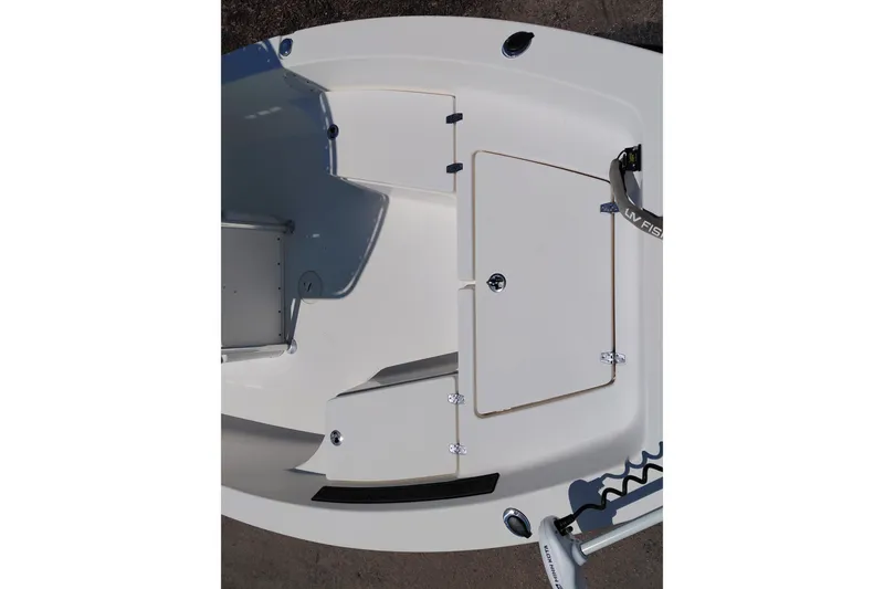 Slide: The Image of 2020 Cobia 21 Bay boat deck with storage compartments and fishing rod holder. - 15