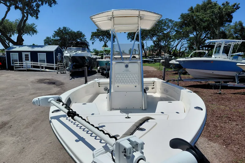 Slide: The Image of 2020 Cobia 21 Bay boat with T-top, parked outdoors on a sunny day. - 13