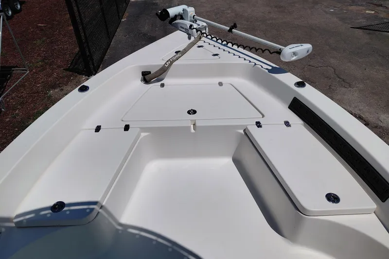 Slide: The Image of 2020 Cobia 21 Bay boat deck with storage compartments and trolling motor. - 16