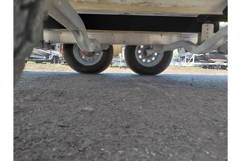 Slide: The Image of Underside view of 2020 Cobia 21 Bay boat trailer wheels on pavement. - 42