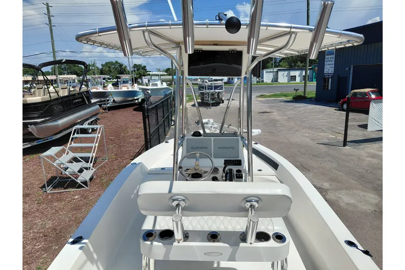 Slide: The Image of 2020 Cobia 21 Bay boat with T-top and Garmin navigation system, parked outdoors. - 40