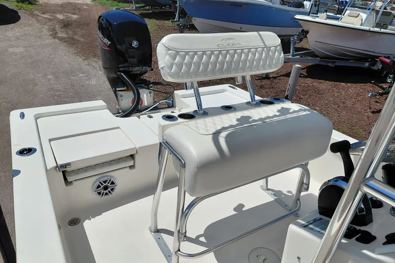 Slide: The Image of 2020 Cobia 21 Bay boat interior with Mercury engine and cushioned seating. - 26