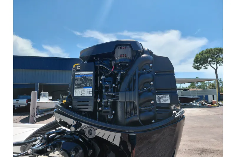 Slide: The Image of 2020 Cobia 21 Bay boat engine, detailed view under clear blue sky. - 44