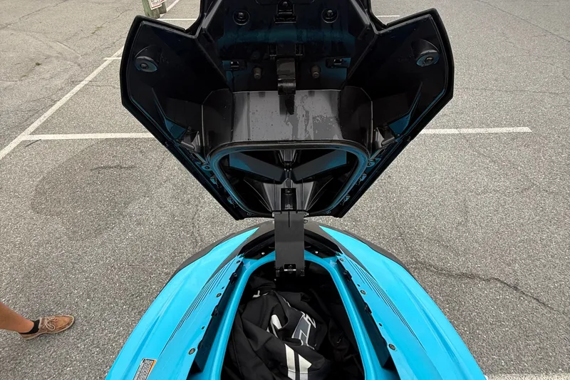 Slide: The Image of Open storage compartment of a 2022 Yamaha GP-1800 jet ski in a parking lot. - 14