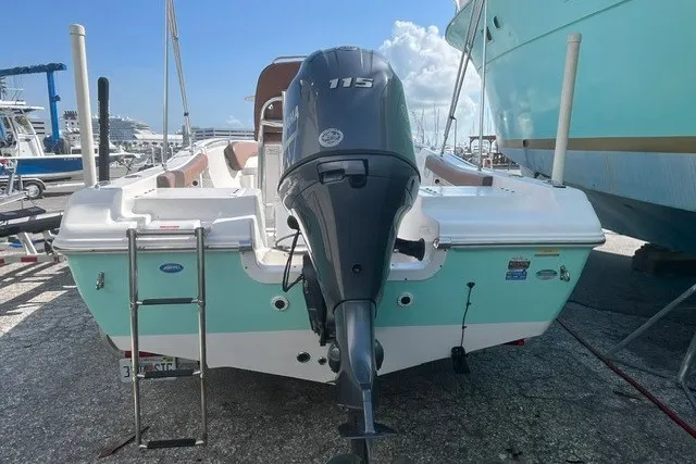 Slide: The Image of 2017 Tidewater 198 CC Adventure boat with 115 HP outboard motor, docked at marina. - 14