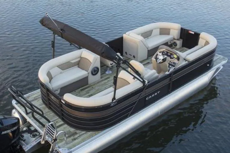 Slide: The Image of Manufacturer Provided Image: 2021 Crest Classic DLX 220 SLC pontoon boat on water, featuring spacious seating and a sleek design. - 1