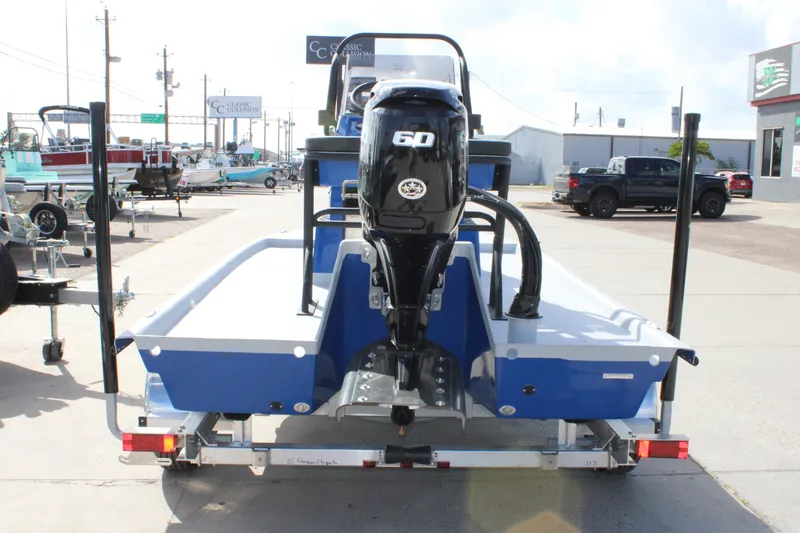 Slide: The Image of Freedom Boats Chiquita 2027 model with 60 HP engine on trailer, outdoor display. - 6