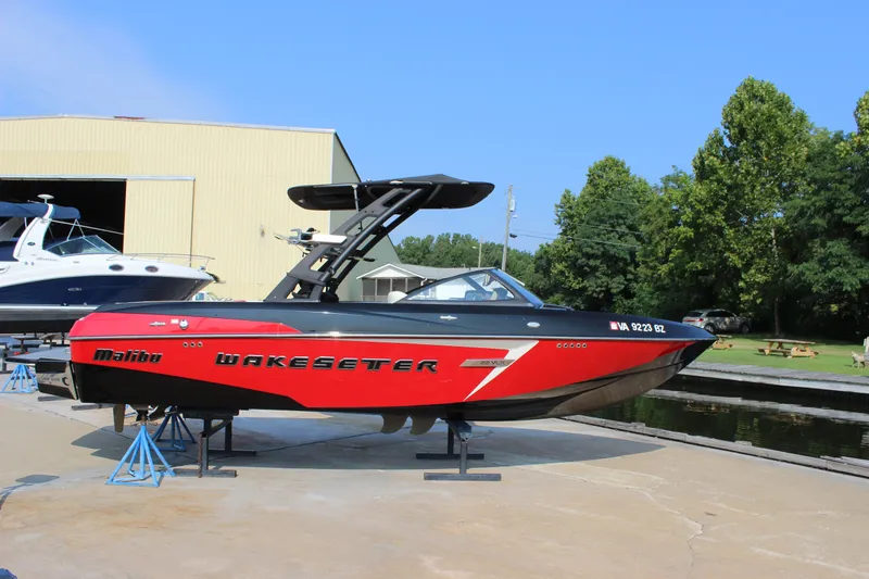Slide: The Image of 2015 Malibu Wakesetter 22 VLX boat on display, red and black design. - 1
