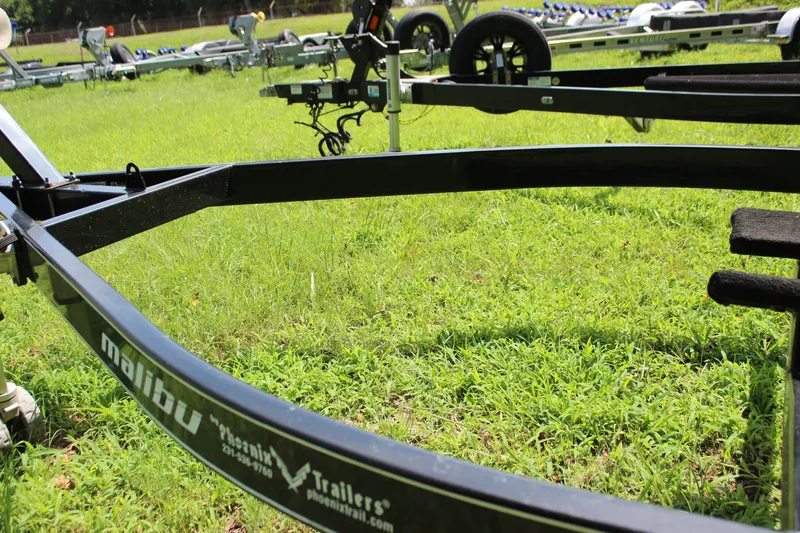 Slide: The Image of Trailer for 2015 Malibu Wakesetter 22 VLX on grassy field. - 47
