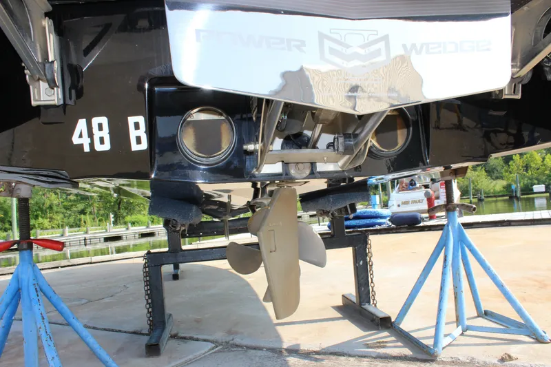 Slide: The Image of Close-up of the stern of a 2015 Malibu Wakesetter 22 VLX, propped on stands. - 35