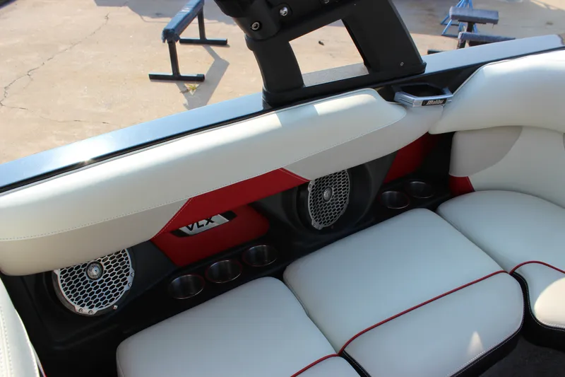 Slide: The Image of 2015 Malibu Wakesetter 22 VLX interior with white and red seating, speakers, and cup holders. - 14