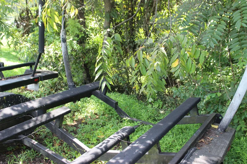 Slide: The Image of Boat trailer for 2015 Malibu Wakesetter 22 VLX surrounded by lush greenery. - 46