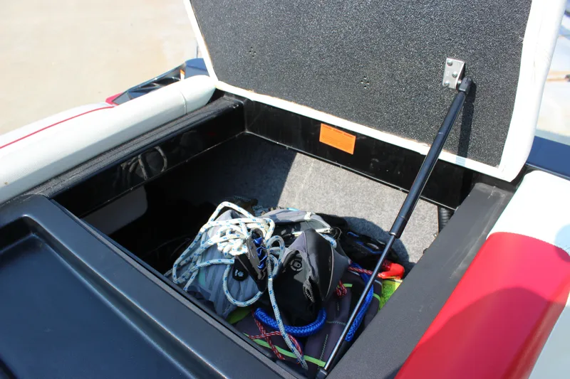 Slide: The Image of Open storage compartment in 2015 Malibu Wakesetter 22 VLX boat with ropes and gear. - 15