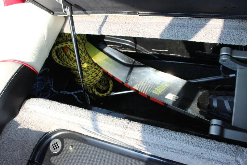 Slide: The Image of Storage compartment in 2015 Malibu Wakesetter 22 VLX with water ski and rope. - 19