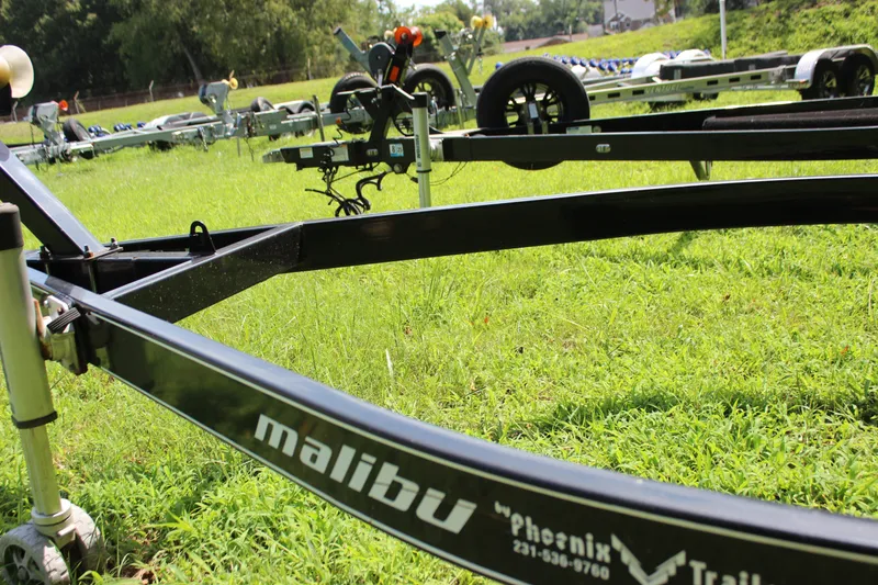 Slide: The Image of Trailer for 2015 Malibu Wakesetter 22 VLX on grassy field. - 48