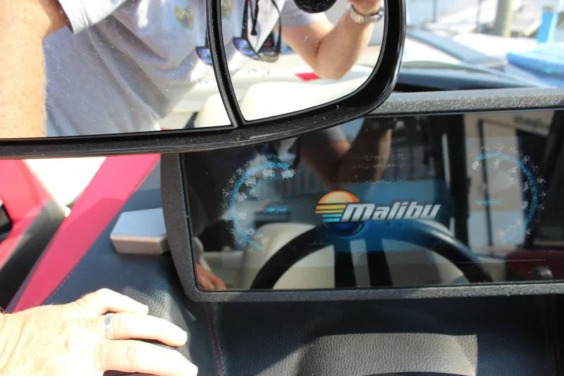 Slide: The Image of 2015 Malibu Wakesetter 22 VLX dashboard with logo and rearview mirror reflection. - 22