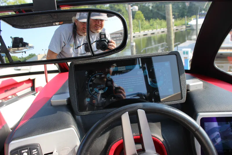 Slide: The Image of 2015 Malibu Wakesetter 22 VLX dashboard with digital display and rearview mirror reflection. - 24
