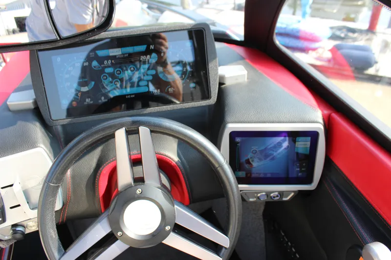 Slide: The Image of 2015 Malibu Wakesetter 22 VLX dashboard with digital displays and steering wheel. - 26