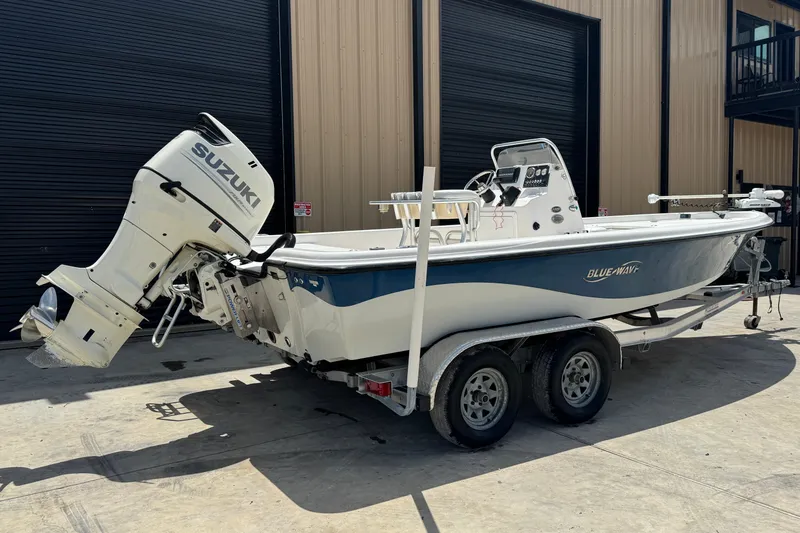 Slide: The Image of 2018 Blue Wave 2200 PureBay boat with Suzuki outboard motor on trailer. - 19