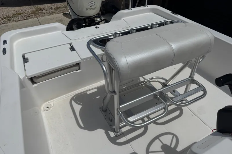 Slide: The Image of 2018 Blue Wave 2200 PureBay boat interior with seating and steering wheel. - 13