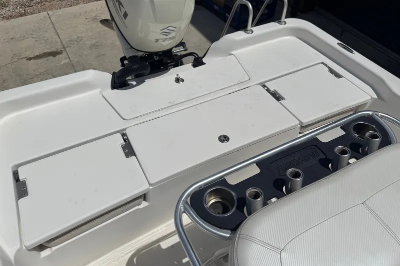 Slide: The Image of 2018 Blue Wave 2200 PureBay boat deck with Suzuki 175 engine and rod holders. - 16
