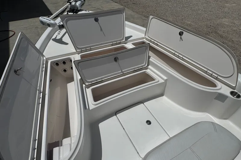 Slide: The Image of 2018 Blue Wave 2200 PureBay boat with open storage compartments and seating area. - 15